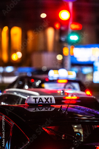 Close-up of a taxi in a traffic jam in the center of big city at night.