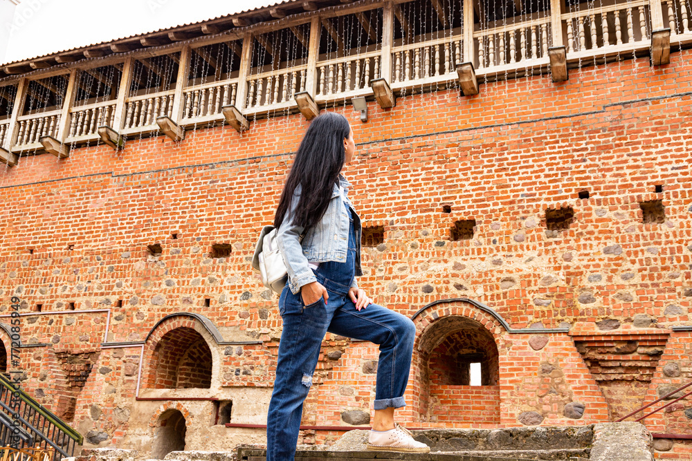 A young girl on excursions in an ancient castle. - obrazy, fototapety, plakaty 
