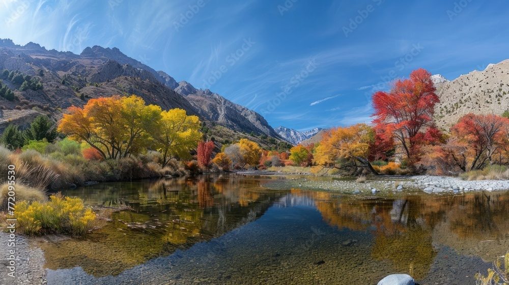 Panoramic autumn scenery with vibrant foliage along a tranquil river, reflective water, surrounded by mountains under a wispy clouded sky. Panoramic autumn scenery with vibrant foliage along a tranquil river, reflective water, surrounded by mountains under a wispy clouded sky.
