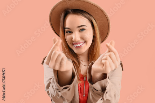 Young woman making heart wi...