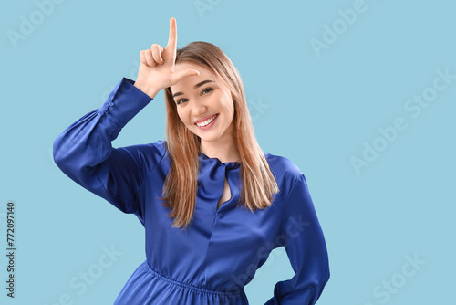 Young woman showing loser g...