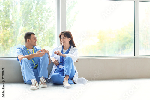 Young doctors sitting in ha...