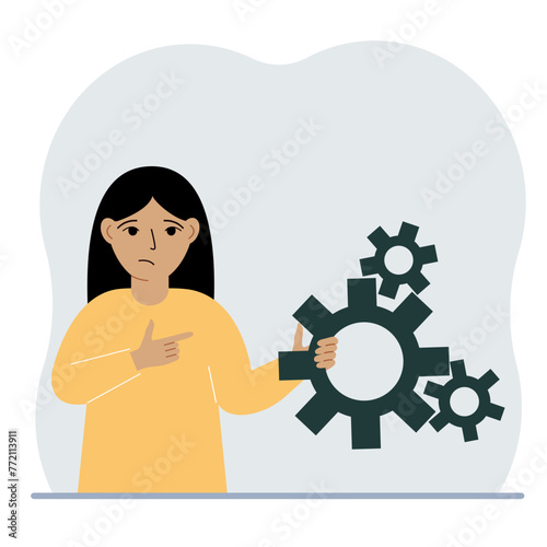 A little girl holds gears in his hands. The concept of searching for an idea, reflection or learning process.