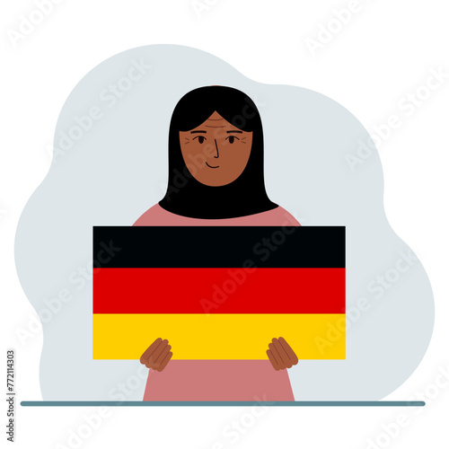 A woman holds a German flag in his hands. The concept of demonstration, national holiday or patriotism. Nationality.