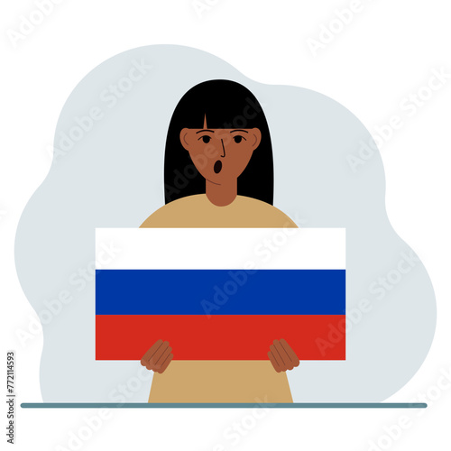 A woman holds a Russian flag in his hands. The concept of demonstration, national holiday or patriotism. Nationality.