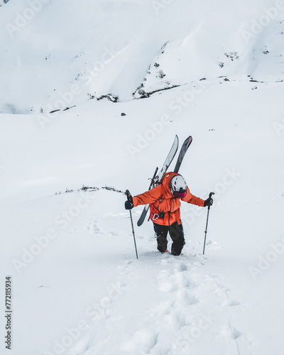 Cuadro en lienzo Mountaineer walking up along a snowy mountain with the skis in the backpack