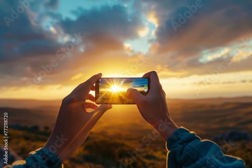 A person using their cell phone to capture a scenic landscape, holding the device up to take a photo