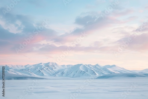 A wide-angle shot of a snow-covered landscape at dawn, with soft pastel hues in the sky and snow-capped mountains in the distance