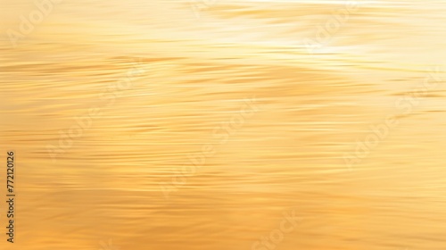 Golden sunlight reflecting on tranquil water surface, creating a smooth, rippling texture with a warm, serene ambiance.