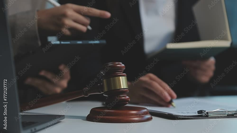 Business and lawyers discussing contract papers with brass scale on desk in office. Law, legal services, advice, justice and law concept picture with film grain effect Business and lawyers discussing contract papers with brass scale on desk in office. Law, legal services, advice, justice and law concept picture with film grain effect