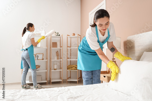 Female janitor making bed i...