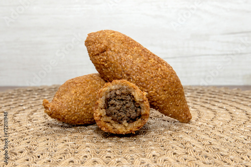 Kibbe Lebanese food, traditional Arabic snack, Kibbeh is a fried recipe filled with minced meat, which is characterized by its ovoid shape finished with two pointed ends. photo