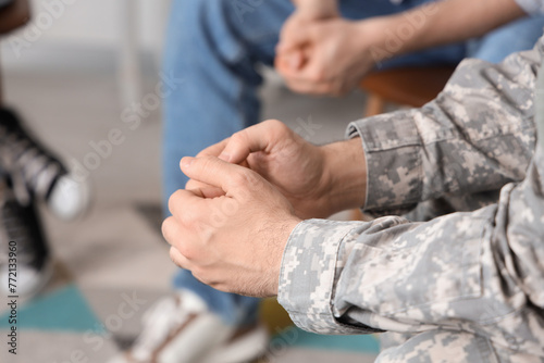 Male soldier sitting at group therapy session  closeup