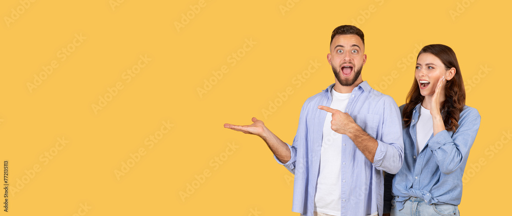 Excited man presenting with woman Excited man presenting with woman