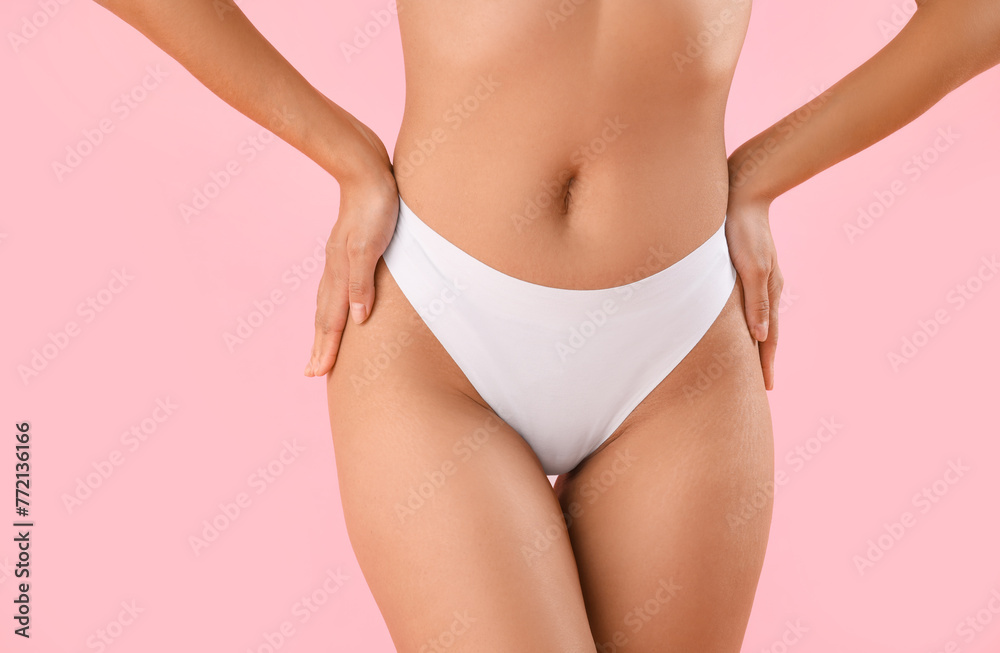 Fototapeta premium Beautiful young African-American woman with stretch marks on her body against pink background, closeup
