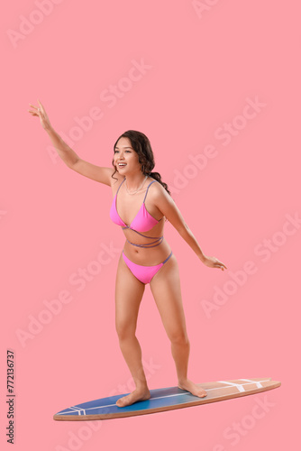 Sexy young woman on surfboa...