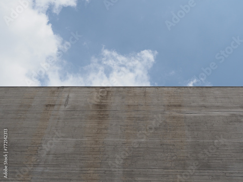 grey concrete wall over blue sky background (ID: 772142313)