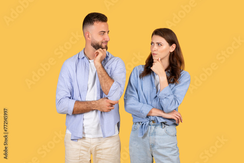 Two people contemplating with hand on chin photo