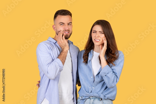 Man and woman with tooth pain expressions