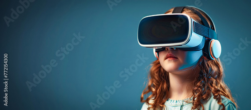 Little girl wearing virtual reality glasses on blue background with copy space banner for advertising of vr technology in education and entertainment industry