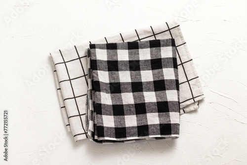 Gingham napkins with black and white checks on the table.