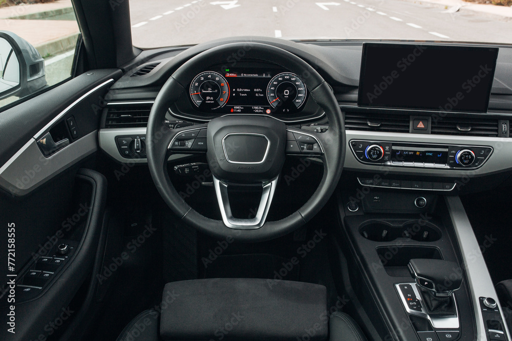 Modern expensive car interior with leather panel, sport seats, multimedia and digital dashboard Modern expensive car interior with leather panel, sport seats, multimedia and digital dashboard