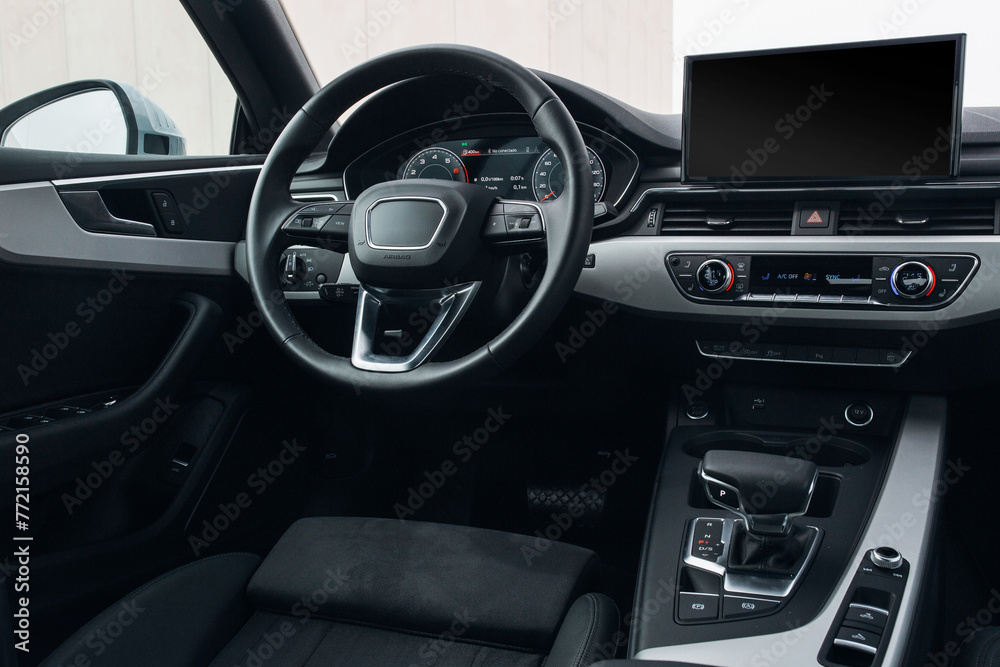 Modern expensive car interior with leather panel, sport seats, multimedia and digital dashboard