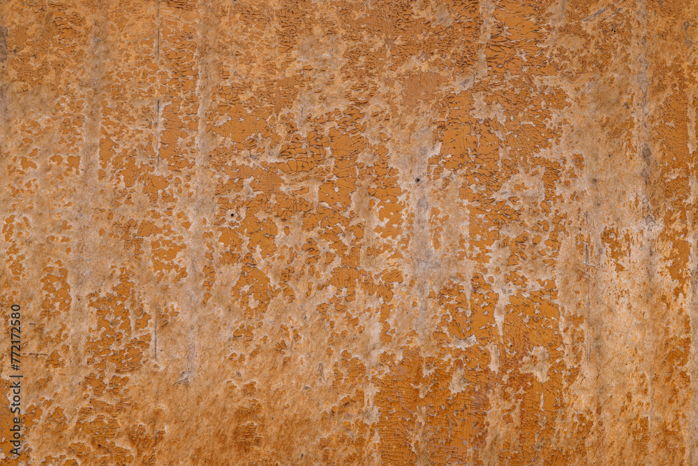 Closeup of a weathered brown fiberboard surface with peeled off brown paint, full-frame background and texture.