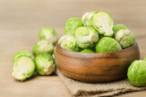 Brussels sprouts in a wooden plate on the table