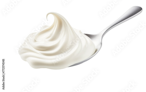 A spoon filled with whipped cream  resting on a pristine white background