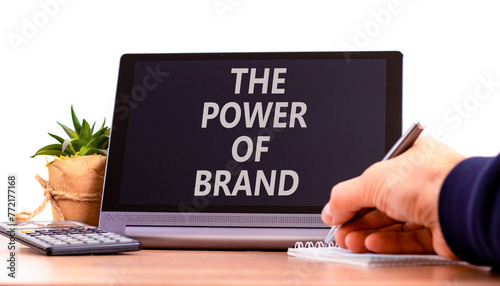 The power of brand symbol. Concept words The power of brand on beautiful black tablet. Beautiful white background. Businessman hand. Calculator. Business the power of brand concept. Copy space.