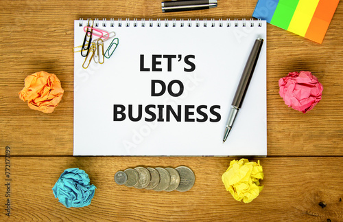 let is do business symbol. Concept words let is do business on beautiful white note. Beautiful wooden background. Black pen. Colored paper. let is do business concept. Copy space.