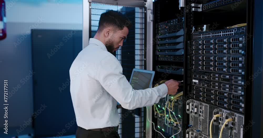 Technician, server room and laptop with cables connection for system maintenance, hardware or software backup. Man or programmer on computer by power engineering, programming or coding in data center