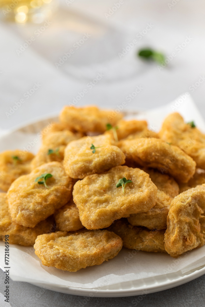 Delicious golden chicken nuggets on a plate close up. Fast food, menu. Delicious golden chicken nuggets on a plate close up. Fast food, menu.