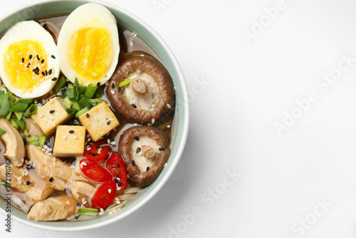 Bowl of delicious ramen isolated on white, top view. Noodle soup