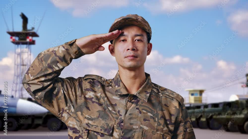 Close Up Of Asian Man Soldier Saluting While Standing At Military Camp Close Up Of Asian Man Soldier Saluting While Standing At Military Camp
