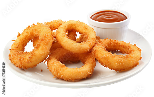A white plate holds golden-brown onion rings beside a cup of ketchup