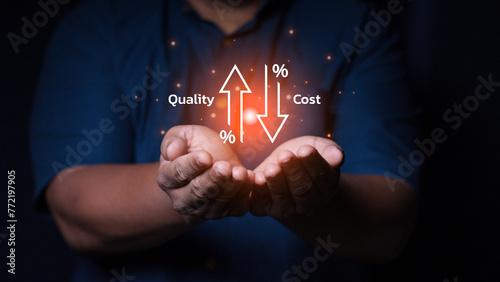 Businessman showing cost with down arrow and quality with up arrow for business project management strategy have to control budget cost and improvement quality of product and service. Quality control photo