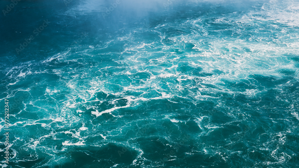 The sea surface as a backdrop. Unquiet sea surface. Waves during a storm. Natural background for advertising and wallpaper. Panoramic composition.