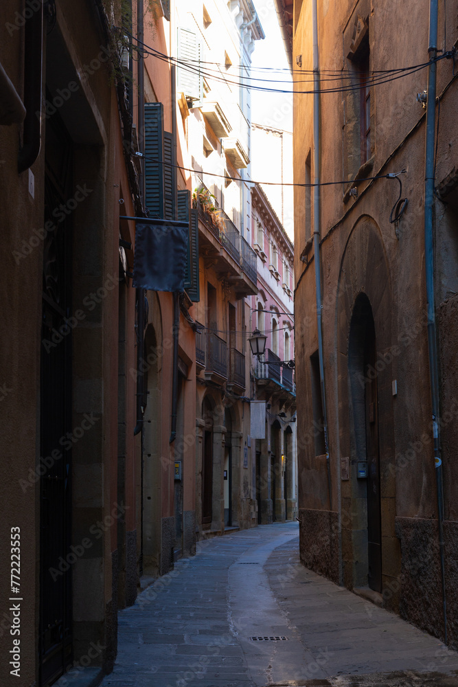 Sunlit alley in vic's historic center