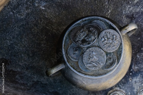 Vitebsk, Belarus, September 9, 2023. Bronze pot with imitation coins.                                photo