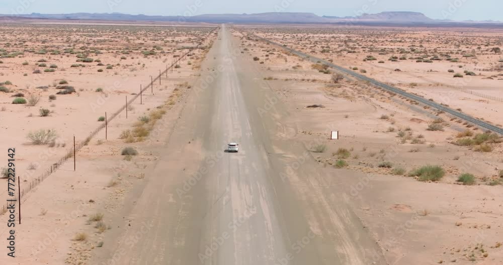 Drone video of a four-wheel drive vehicle driving on a gravel road in a desert area in Namibia Drone video of a four-wheel drive vehicle driving on a gravel road in a desert area in Namibia