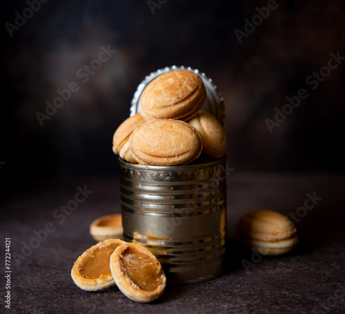 Delicious homemade cookies nuts with boiled condensed milk in a tin can