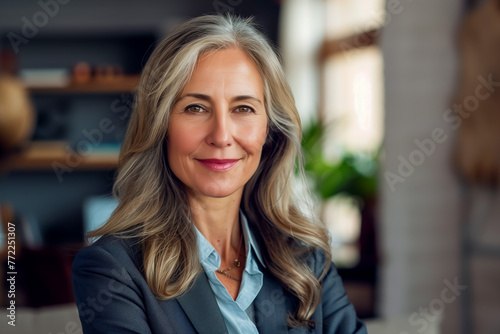 Portrait of middle aged happy business woman in office  closeup