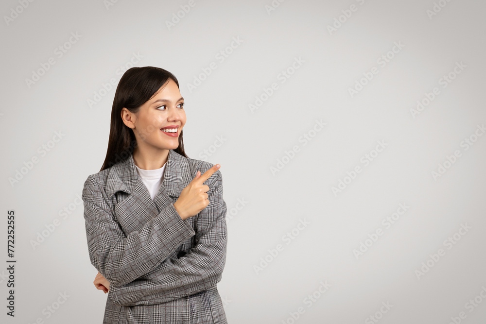 Smiling businesswoman pointing to side at free space, business banner Smiling businesswoman pointing to side at free space, business banner