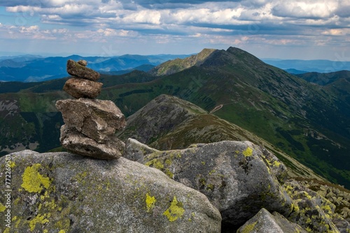 Small stack of stones against the background of majestic mountains in Low Tatras National Park. © Wirestock