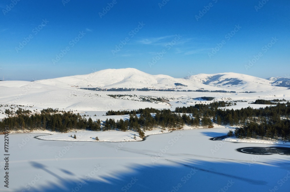 Scenic view of hills covered with snow in winter