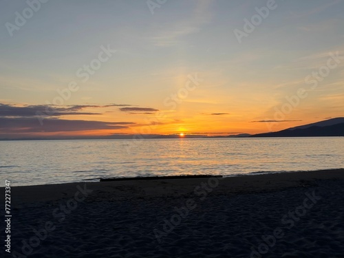 Idyllic sunset scene of an undisturbed beach, featuring a golden sky and calm waters