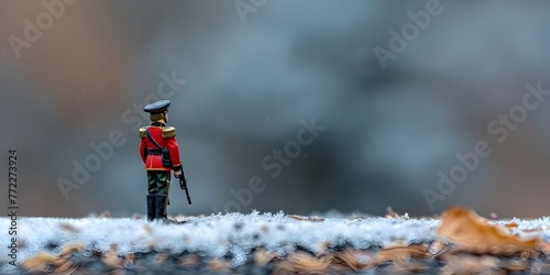 Tiny Toy Soldier Stands Rigid in Formal Military Pose on Isolated Background with Copy Space photo