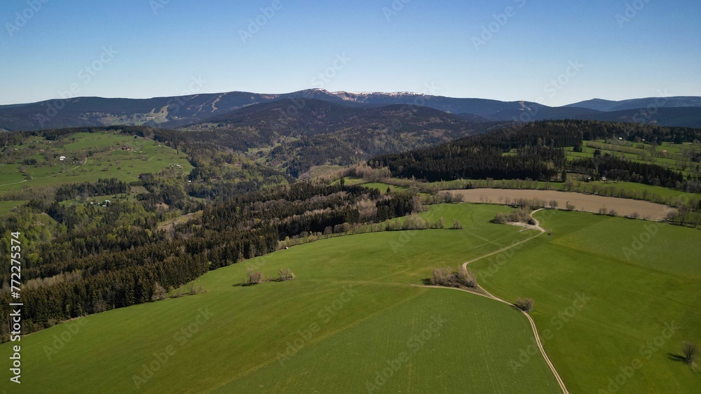 Obraz premium Tranquil countryside landscape features an array of green trees and hills. North Bohemia, Czechia.